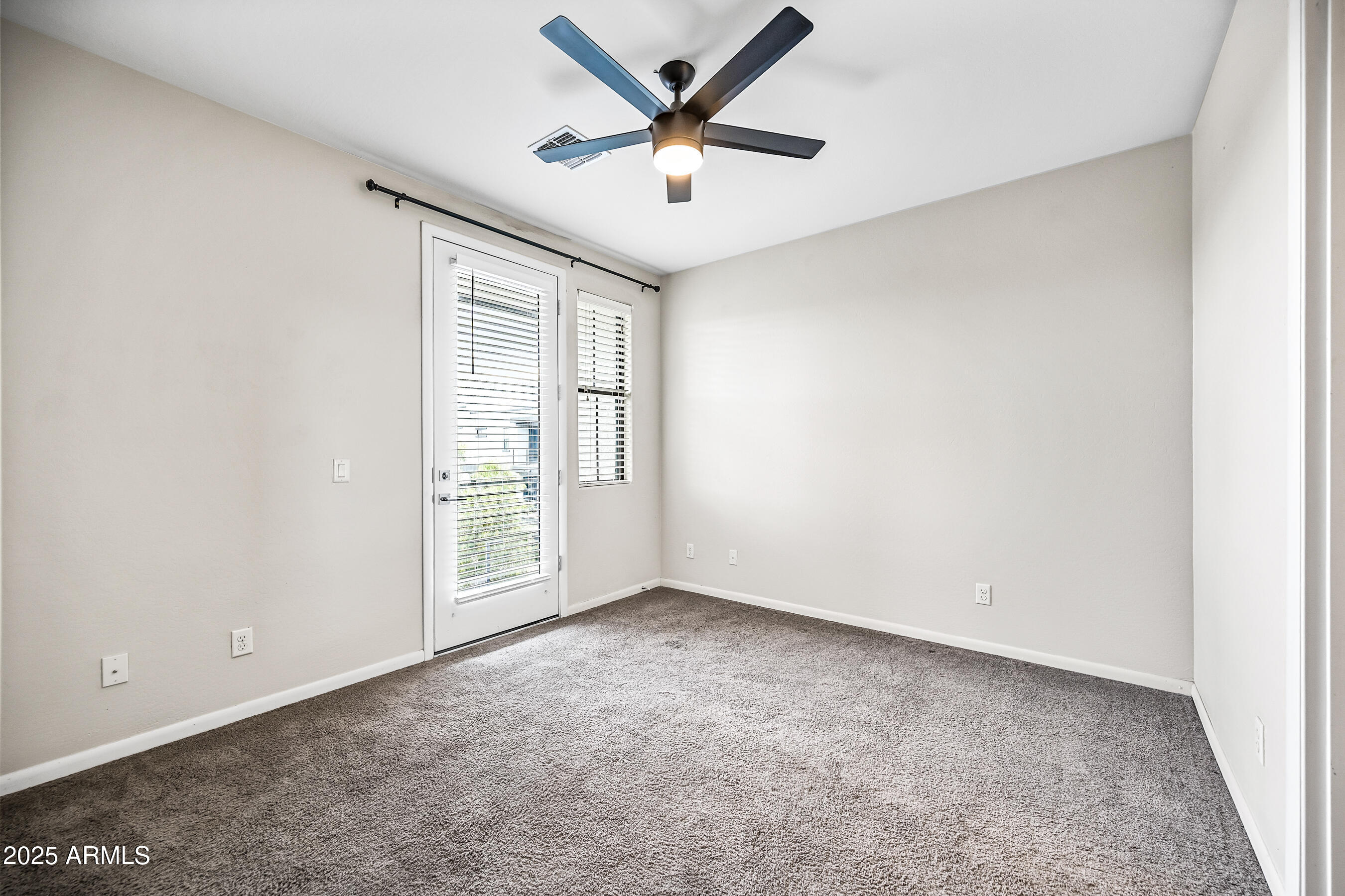 2090 South Dorsey Lane, Unit 1004 Tempe, AZ 85282 - Photo 24 of 31 an empty room with closet and fan
