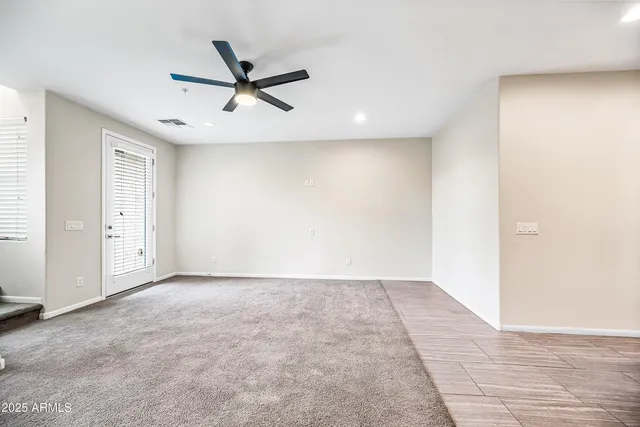 a view of a livingroom with a ceiling fan and window