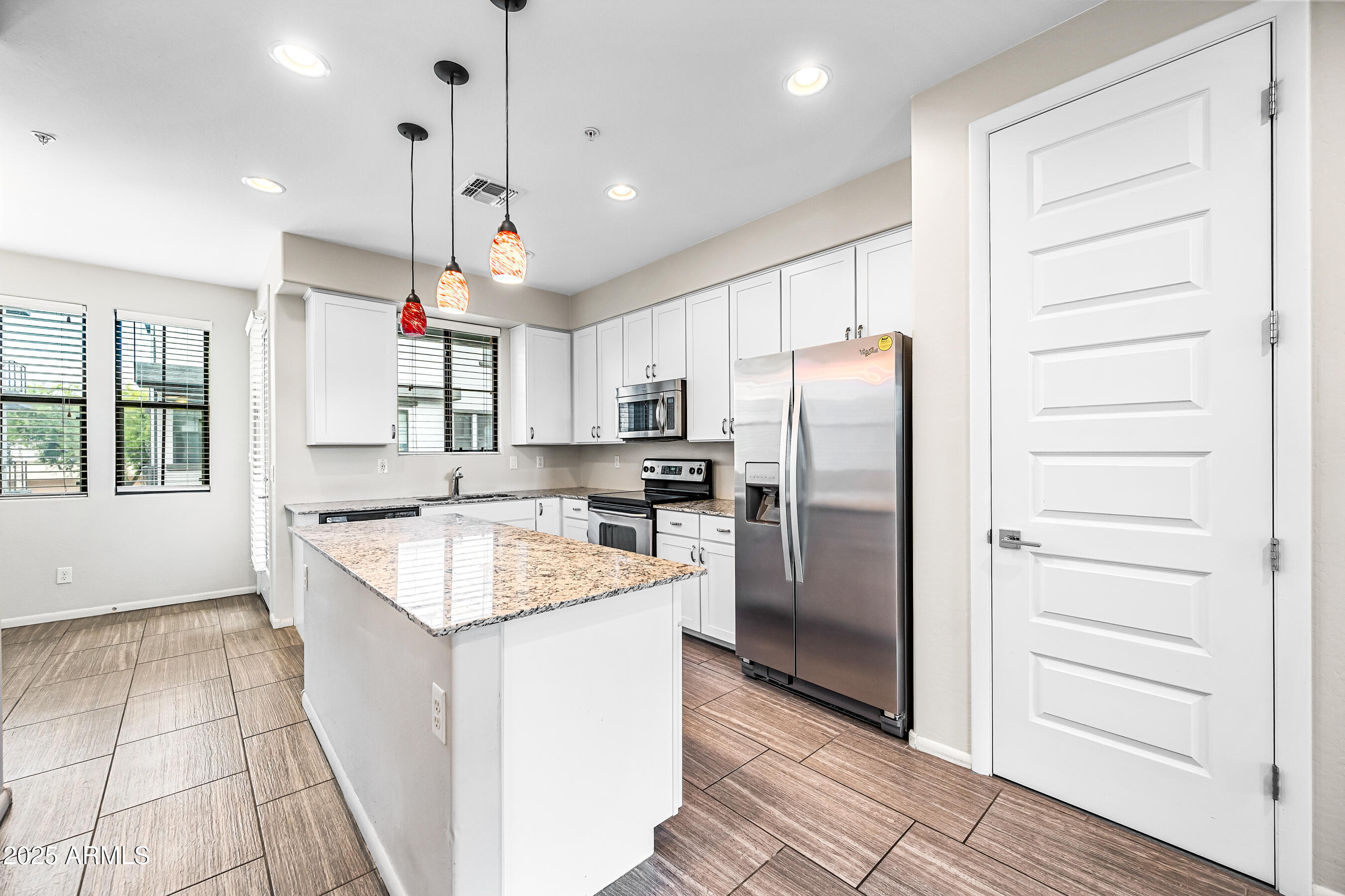 2090 South Dorsey Lane, Unit 1004 Tempe, AZ 85282 - Photo 10 of 31 a kitchen with stainless steel appliances granite countertop a refrigerator a sink a stove and oven