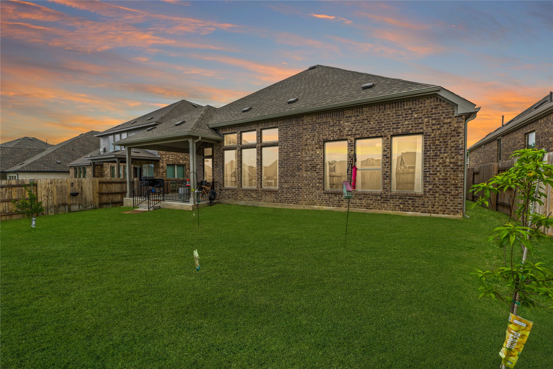 271 Tubman Drive Kyle, TX 78640 - Photo 28 of 40 a view of a house with a big yard and potted plants