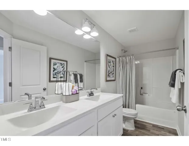 a bathroom with a sink vanity granite and a mirror