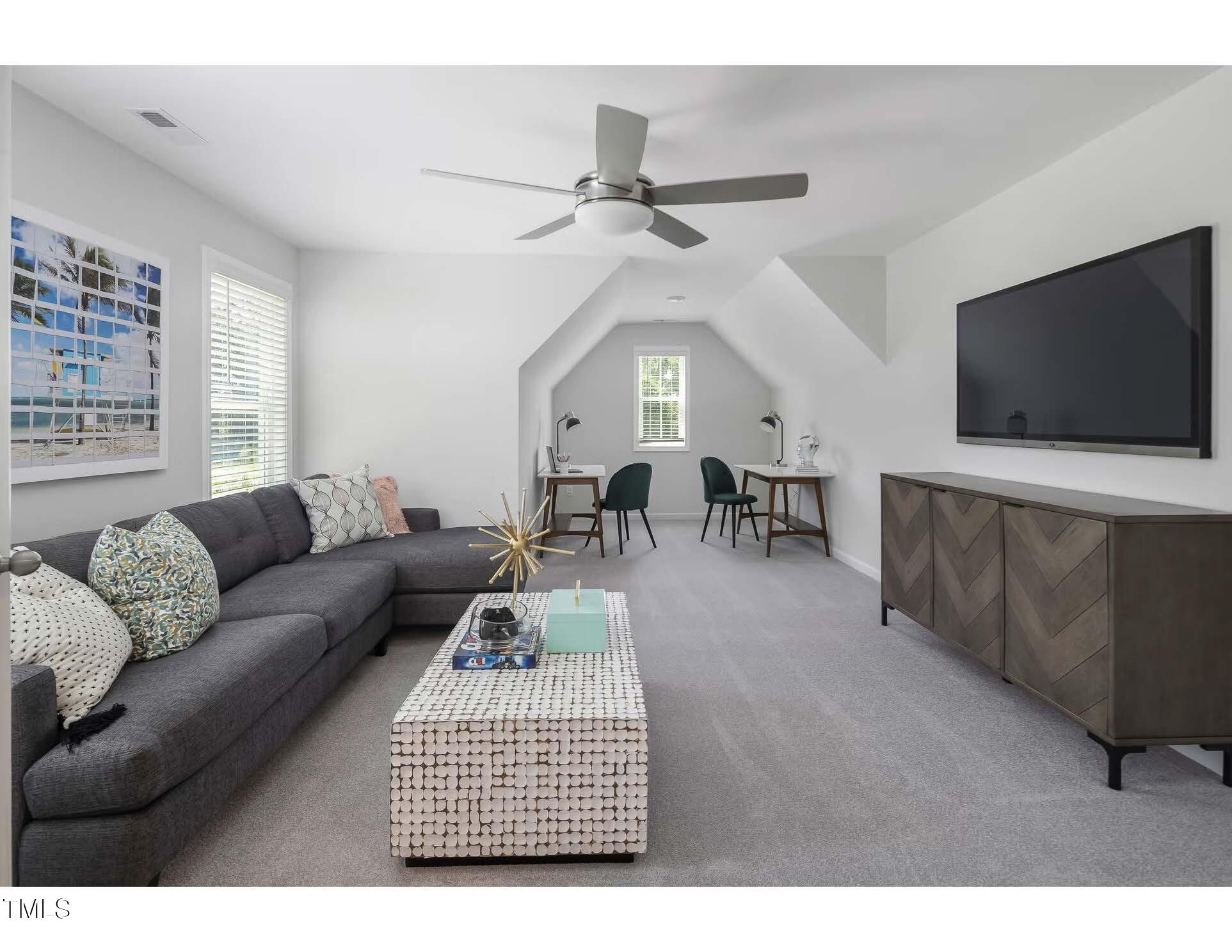 69 White Azalea Way Benson, NC 27504 - Photo 9 of 17 a living room with furniture and a flat screen tv