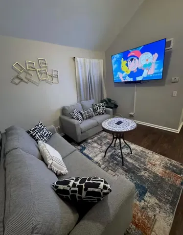 a living room with furniture and a rug