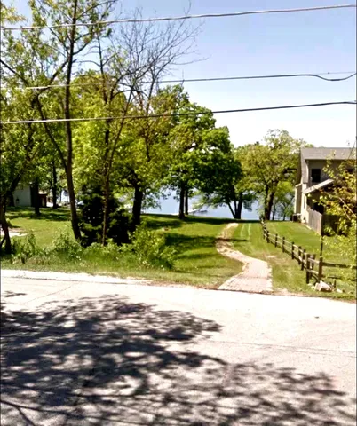 a view of a swimming pool with a yard