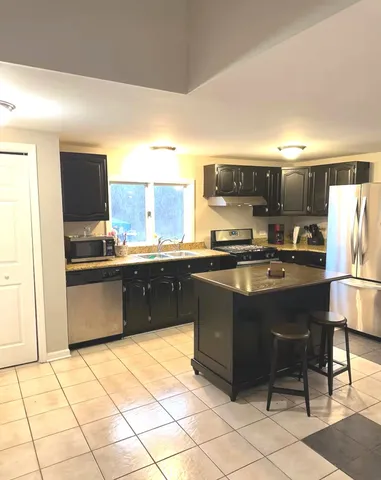 a kitchen with a sink and a refrigerator