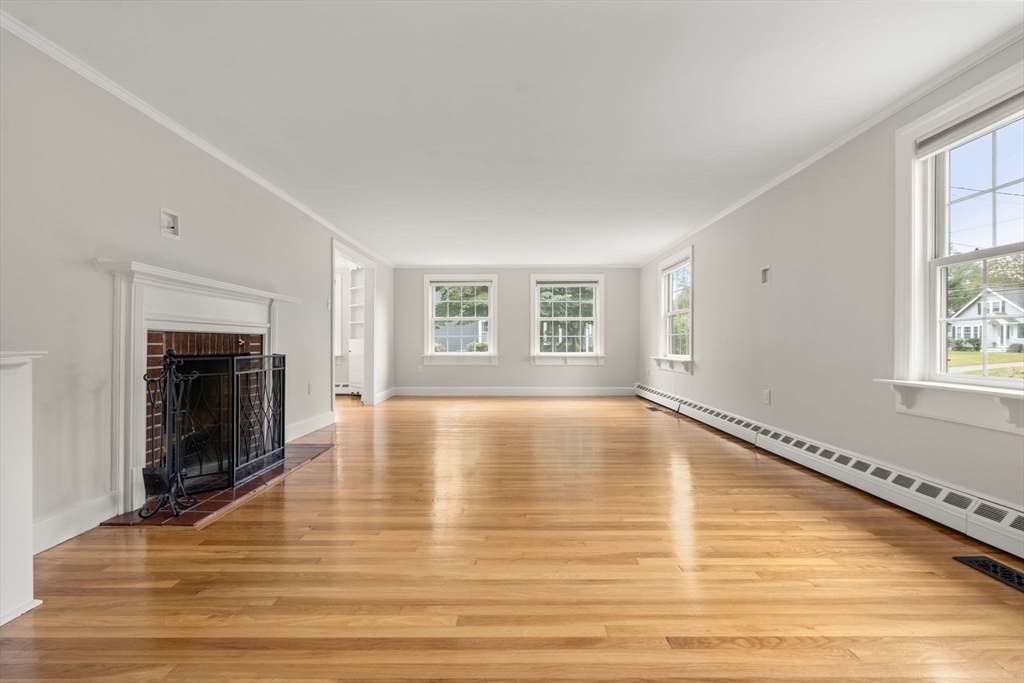92 Abbot Street Andover, MA 01810 - Photo 11 of 35 a view of empty room with wooden floor and fireplace