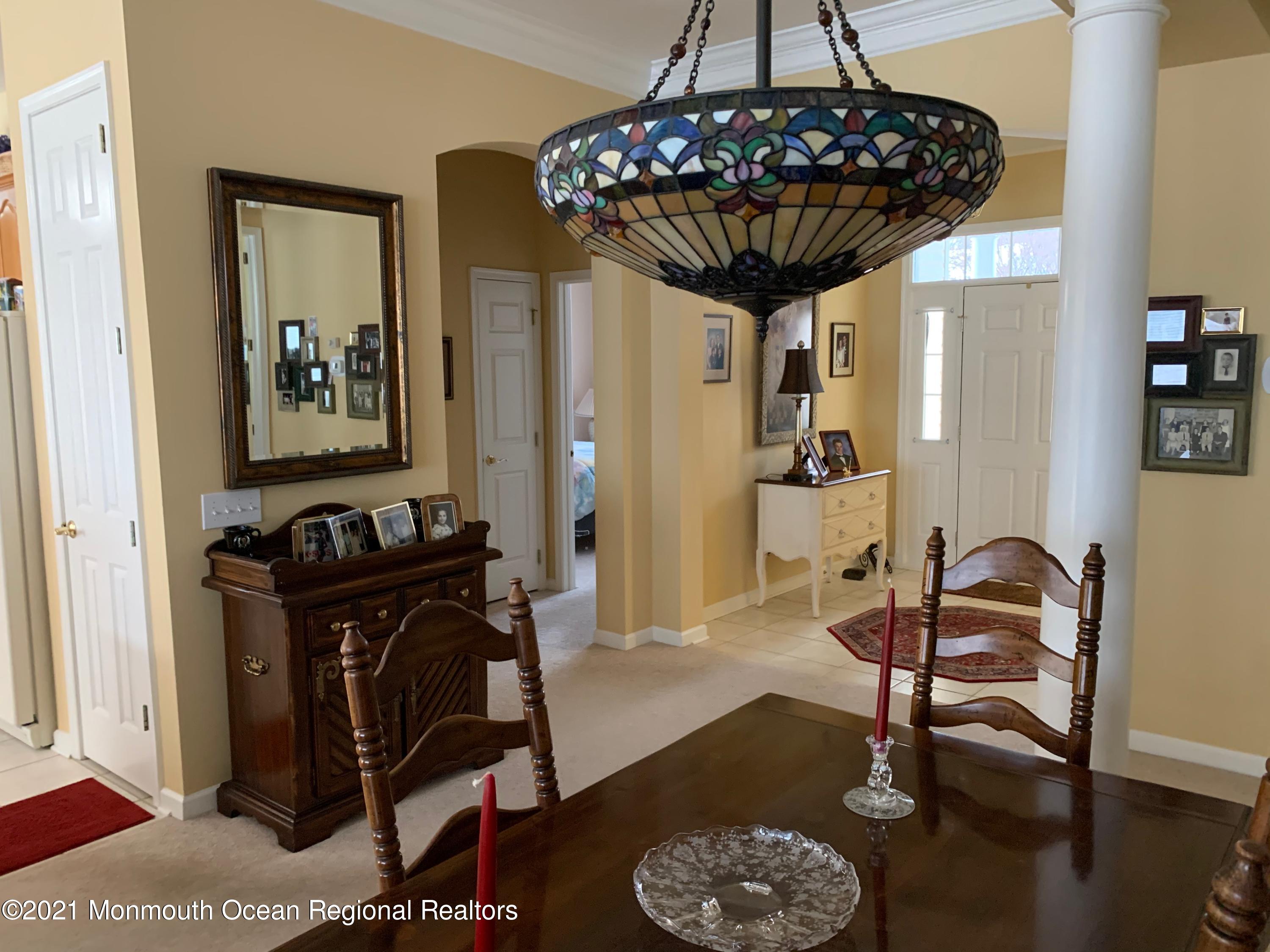 47 Shoal Road Jackson, NJ 08527 - Photo 14 of 56 a living room with furniture and a chandelier