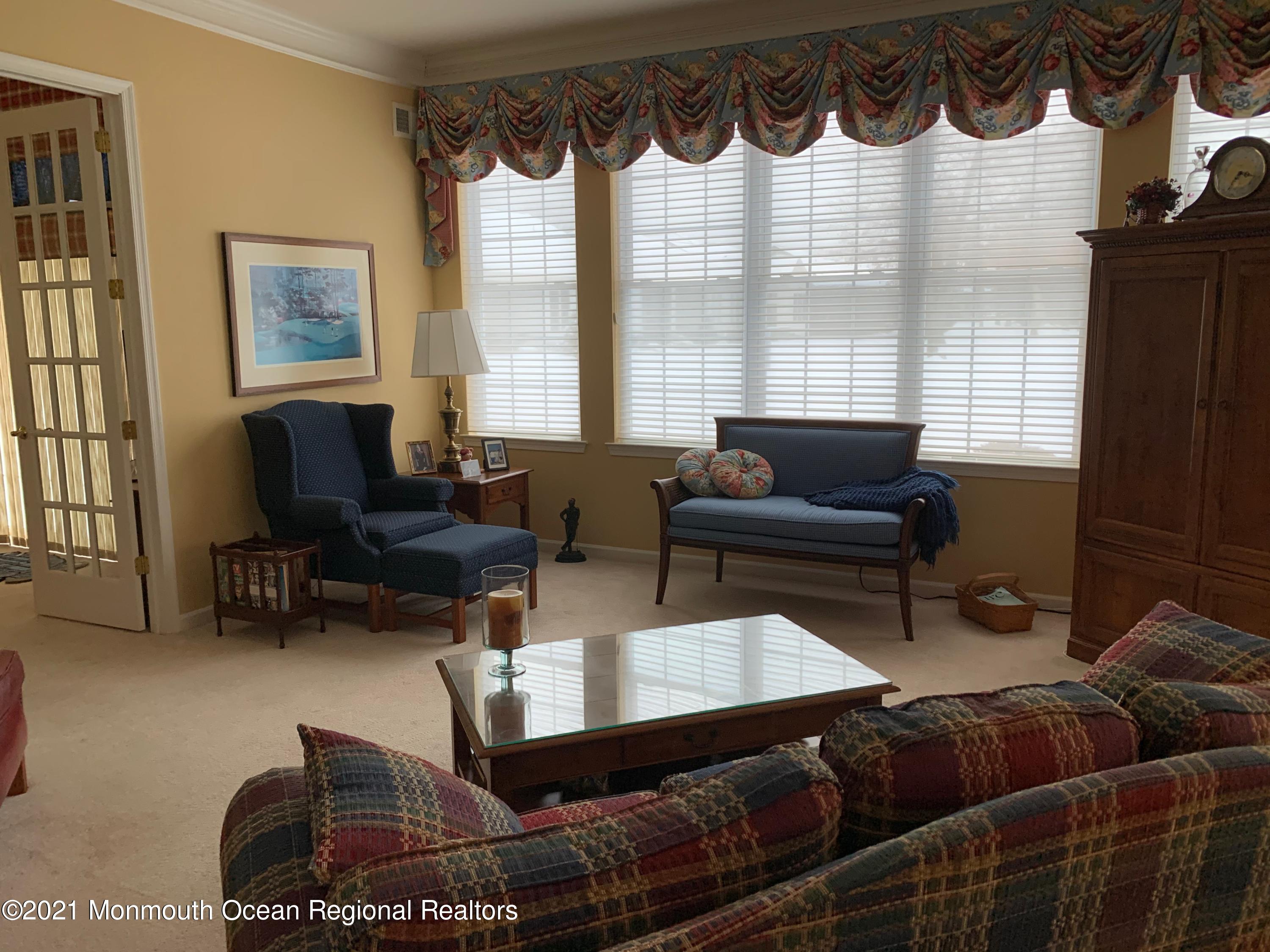 47 Shoal Road Jackson, NJ 08527 - Photo 22 of 56 a living room with furniture fireplace and a large window