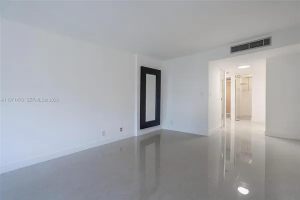 an empty room with windows and closet