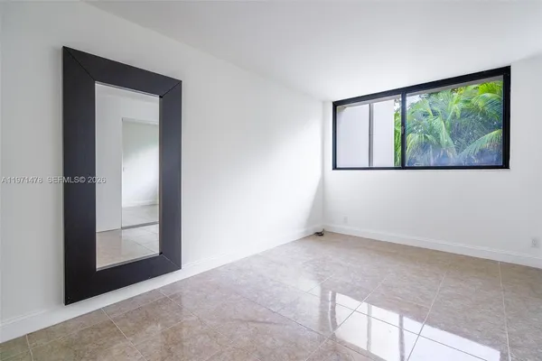 an empty room with windows and closet