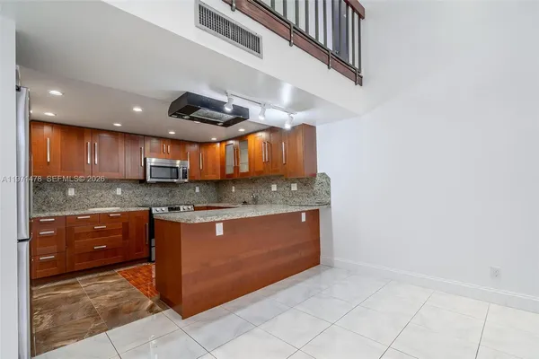 a kitchen with stainless steel appliances granite countertop a stove and a sink