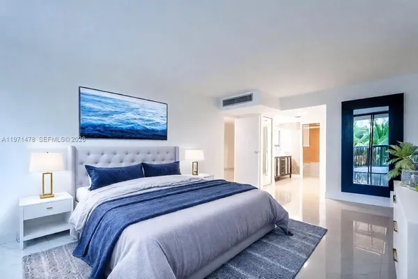a bedroom with a large bed and a large window