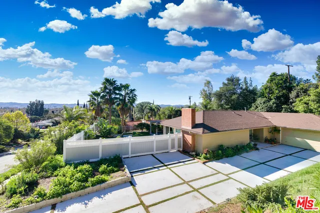 a view of a house with a yard and a garden