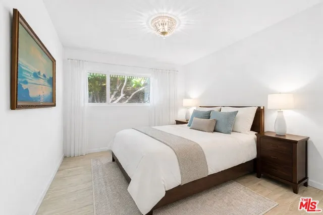 a bedroom with a bed and a night stand