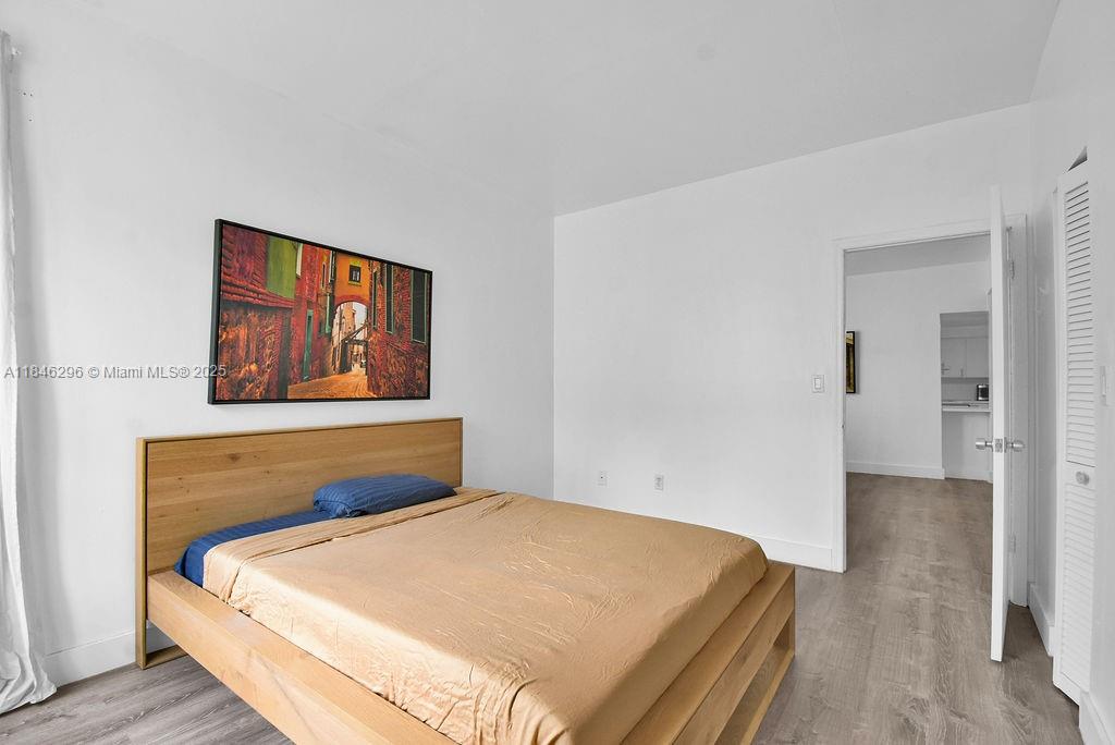 1051 Meridian Avenue, Unit 1C Miami Beach, FL 33139 - Photo 11 of 27 a bedroom with a bed and wooden floor
