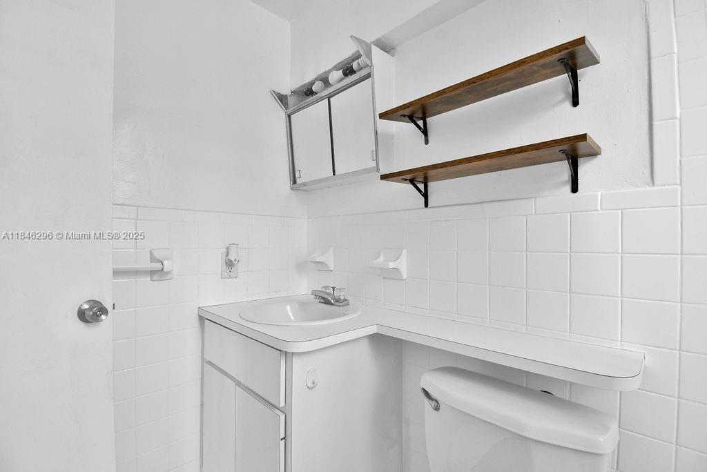 1051 Meridian Avenue, Unit 1C Miami Beach, FL 33139 - Photo 13 of 27 a bathroom with a sink and mirror