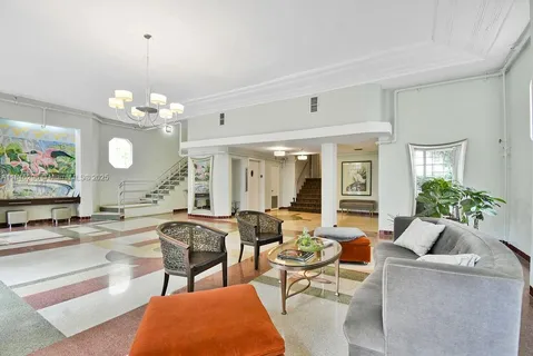 a living room with fireplace furniture and a large window