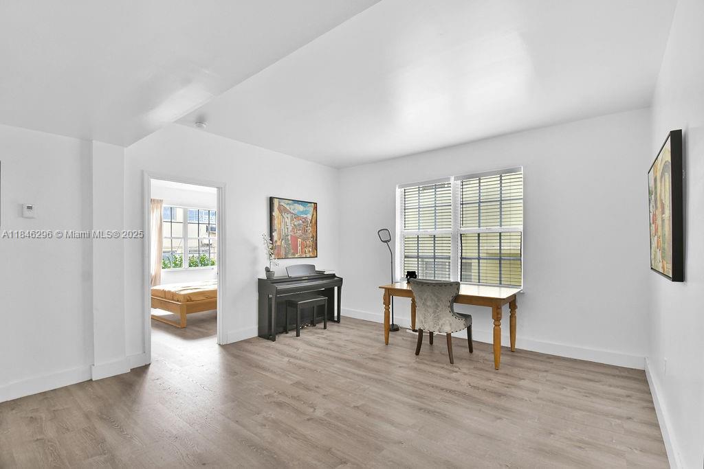 1051 Meridian Avenue, Unit 1C Miami Beach, FL 33139 - Photo 4 of 27 a dining room with furniture and wooden floor