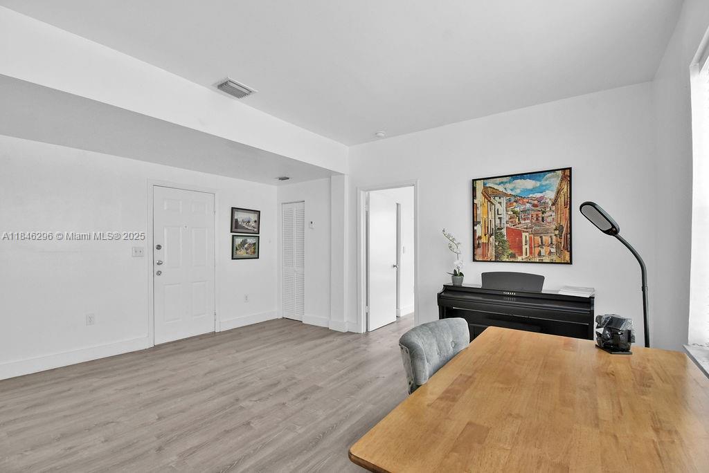 1051 Meridian Avenue, Unit 1C Miami Beach, FL 33139 - Photo 5 of 27 a bedroom with a bed and a piano