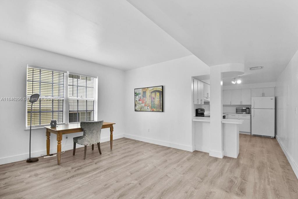1051 Meridian Avenue, Unit 1C Miami Beach, FL 33139 - Photo 6 of 27 a view of a workspace with furniture and wooden floor
