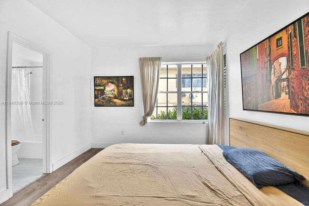 1051 Meridian Avenue, Unit 1C Miami Beach, FL 33139 - Photo 10 of 27 a bedroom with a bed and a large window