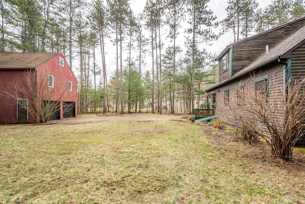 96 Middleton Road Boxford, MA 01921 - Photo 28 of 30 a backyard of a house with large trees and outdoor seating