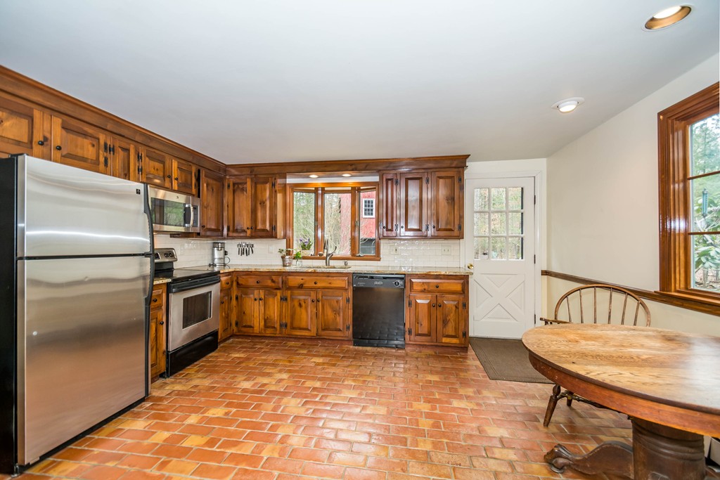 96 Middleton Road Boxford, MA 01921 - Photo 4 of 30 a kitchen with stainless steel appliances granite countertop a refrigerator a sink dishwasher a stove with wooden cabinets and floor