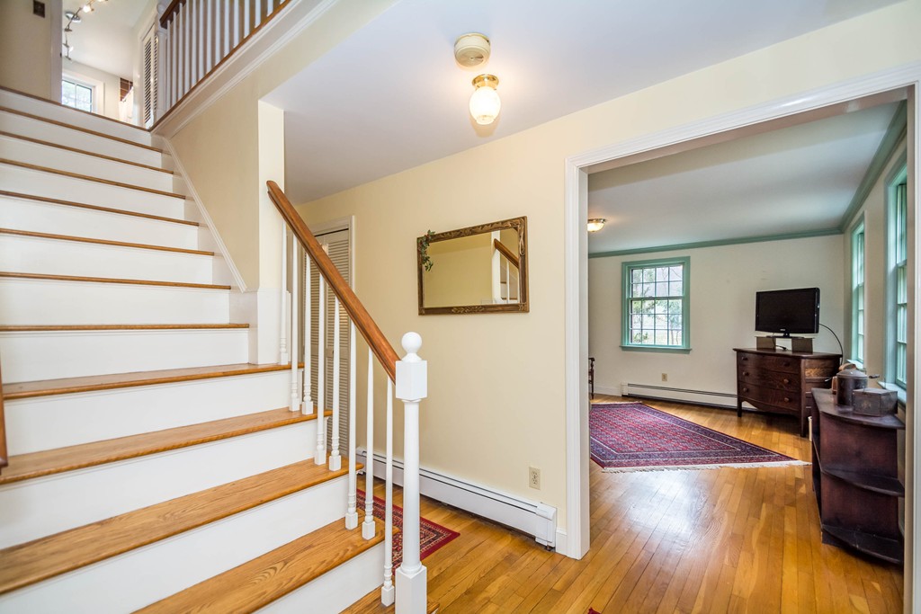 96 Middleton Road Boxford, MA 01921 - Photo 10 of 30 a view of a livingroom with wooden floor and a ceiling fan