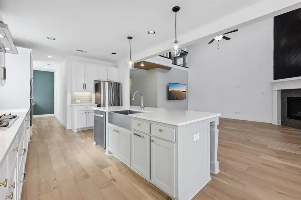 a kitchen with white cabinets and stainless steel appliances