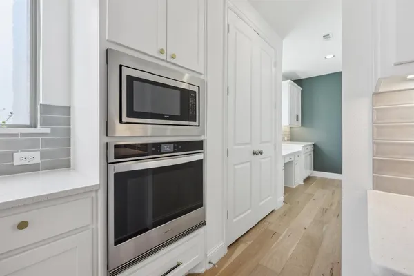 a kitchen with cabinets and steel stainless steel appliances