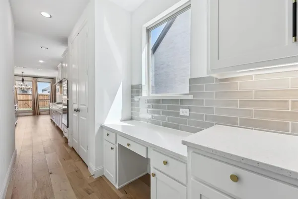 a view of a kitchen with a sink and wooden floor