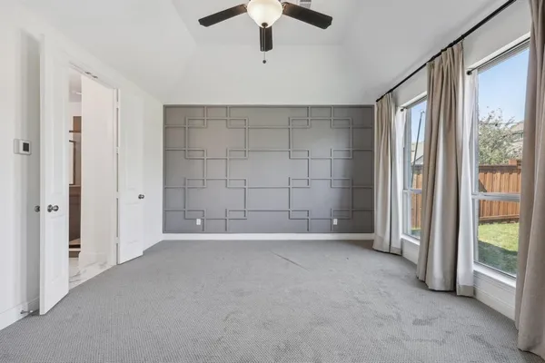 a bathroom with a tub a mirror and a shower
