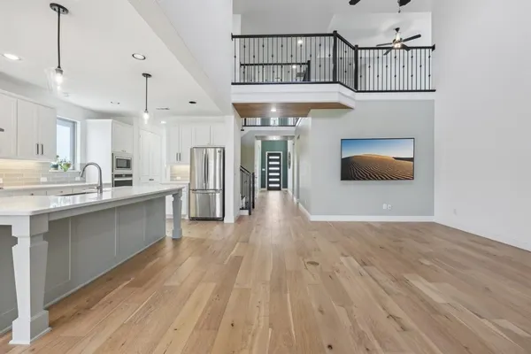 a kitchen with stainless steel appliances granite countertop a hardwood floor sink and stove