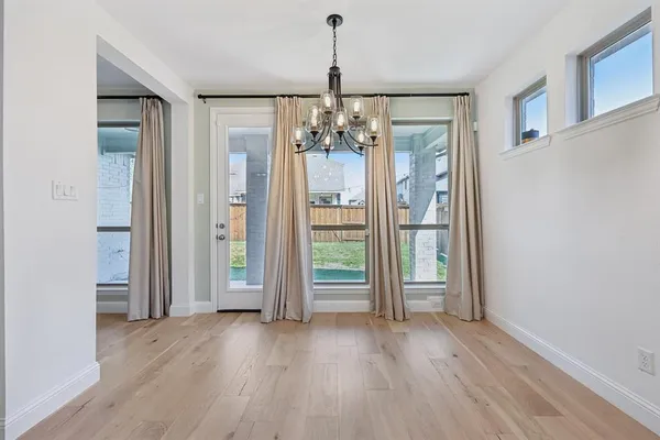 a view of a room with wooden floor wooden floor and windows