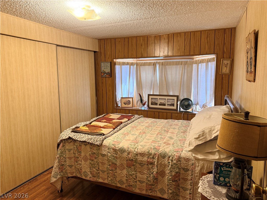 1391 West Dyer Road Pahrump, NV 89048 - Photo 12 of 50 A comforting bedroom space, featuring ample natural light from the bay window and convenient closet storage.