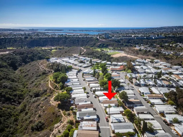an aerial view of a houses with a swimming pool