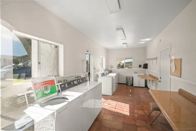 a room with gym equipment and a chandelier