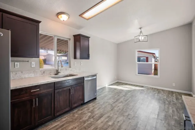 a kitchen with stainless steel appliances granite countertop a stove a sink dishwasher a refrigerator and a oven