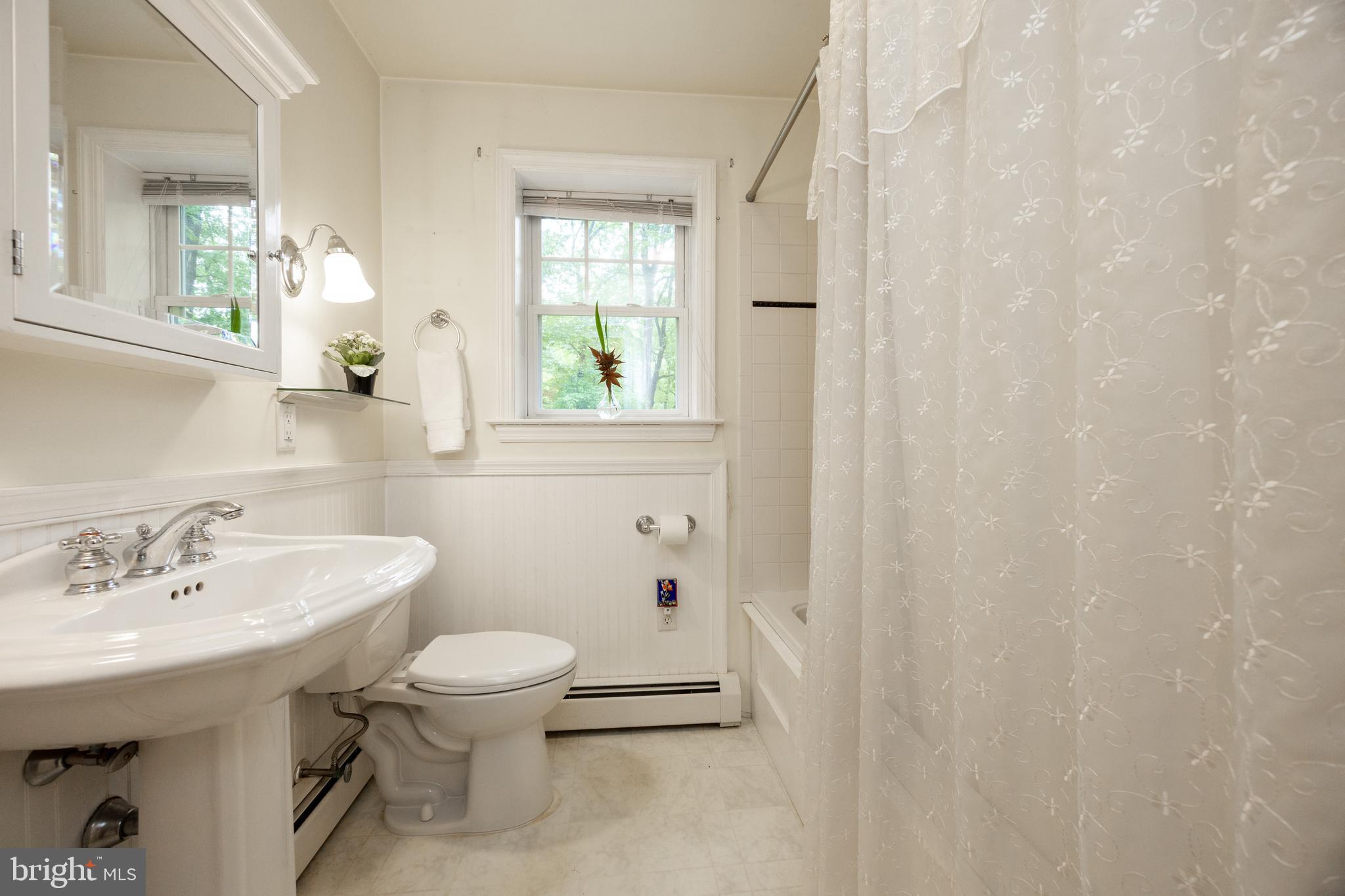 337 Greene Road Berwyn, PA 19312 - Photo 20 of 35 a bathroom with a sink a toilet and a mirror