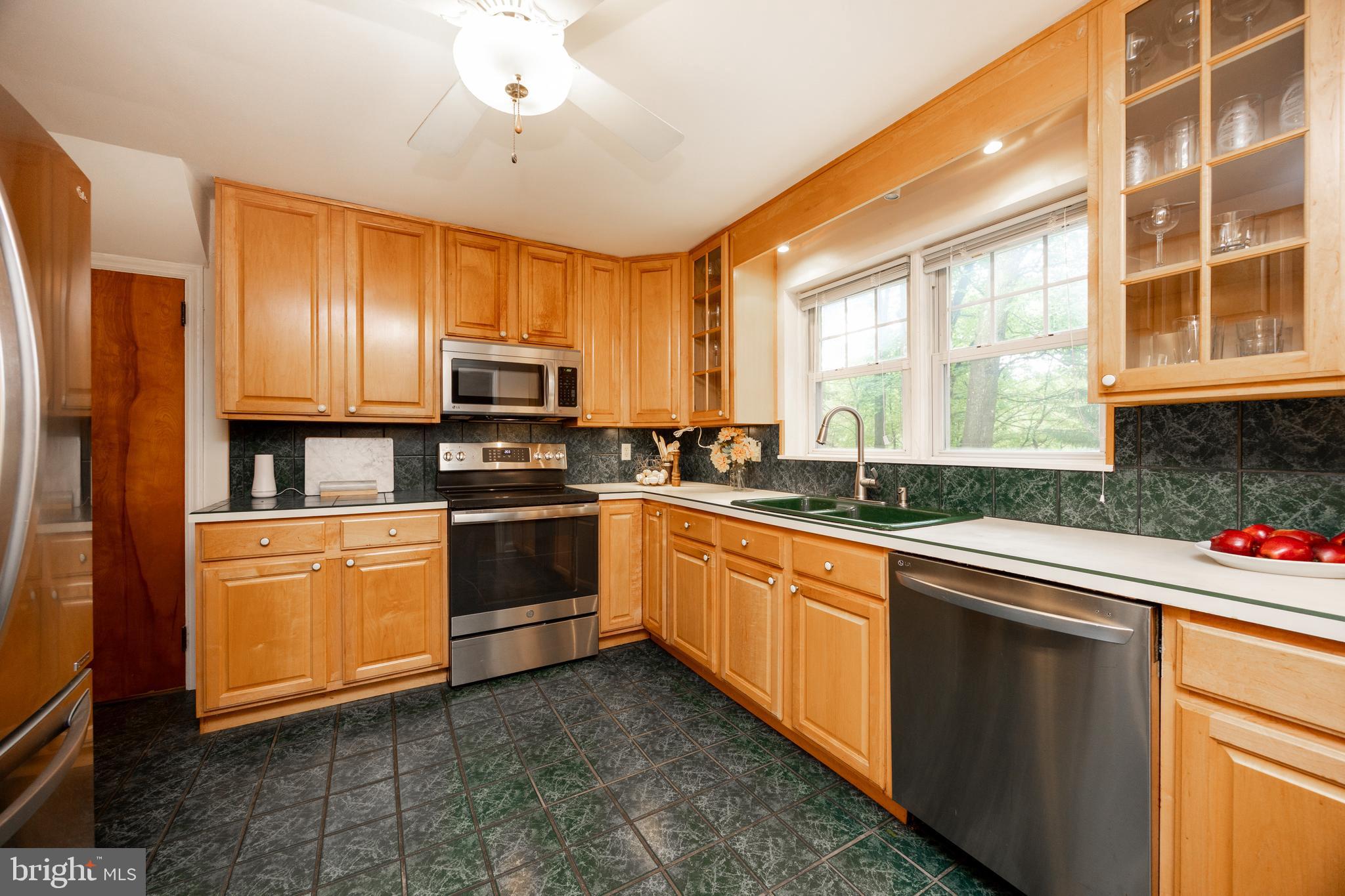 337 Greene Road Berwyn, PA 19312 - Photo 9 of 35 a kitchen with stainless steel appliances granite countertop a stove a sink and a microwave