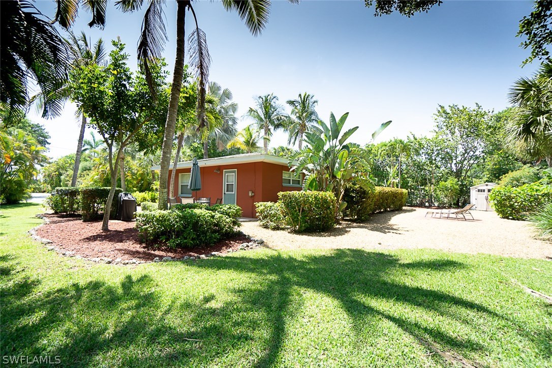 849 Beach Road Sanibel, FL 33957 - Photo 11 of 14 a view of a backyard with potted plants and large trees