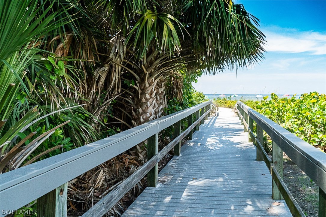 849 Beach Road Sanibel, FL 33957 - Photo 2 of 14 a view of balcony with wooden floor and fence