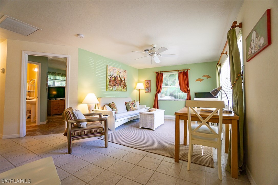849 Beach Road Sanibel, FL 33957 - Photo 3 of 14 a living room with furniture and a large window