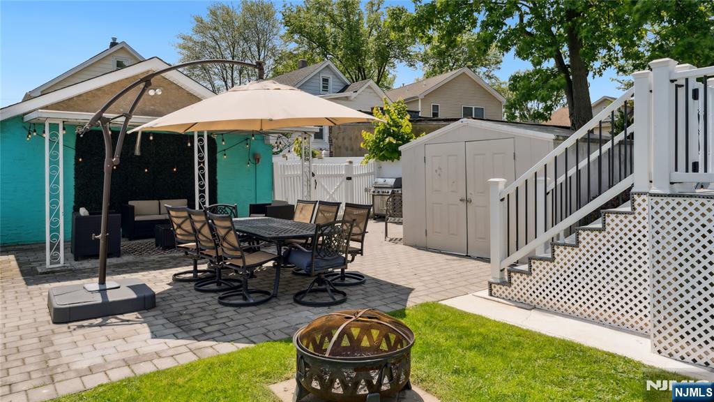 80 Union Avenue Little Ferry, NJ 07643 - Photo 29 of 35 a view of a patio with table and chairs under an umbrella
