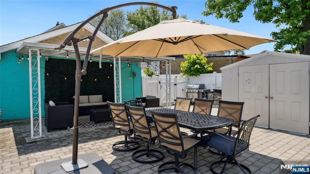80 Union Avenue Little Ferry, NJ 07643 - Photo 30 of 35 a view of a patio with table and chairs under an umbrella