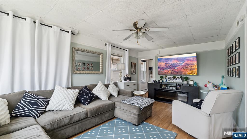 80 Union Avenue Little Ferry, NJ 07643 - Photo 3 of 35 a living room with furniture a ceiling fan and a rug