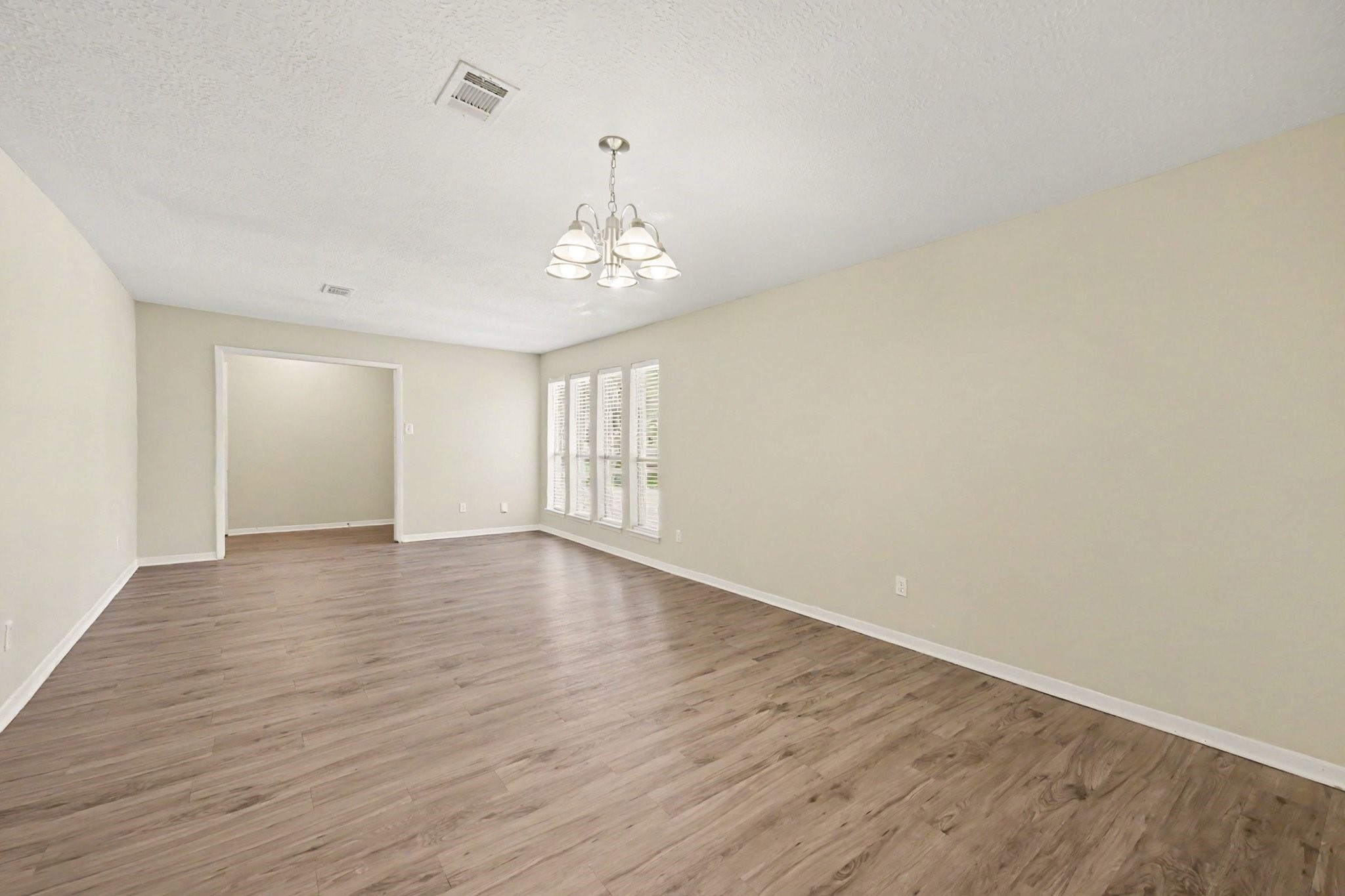 17419 Cassina Drive Spring, TX 77388 - Photo 8 of 35 a view of an empty room with wooden floor and a window