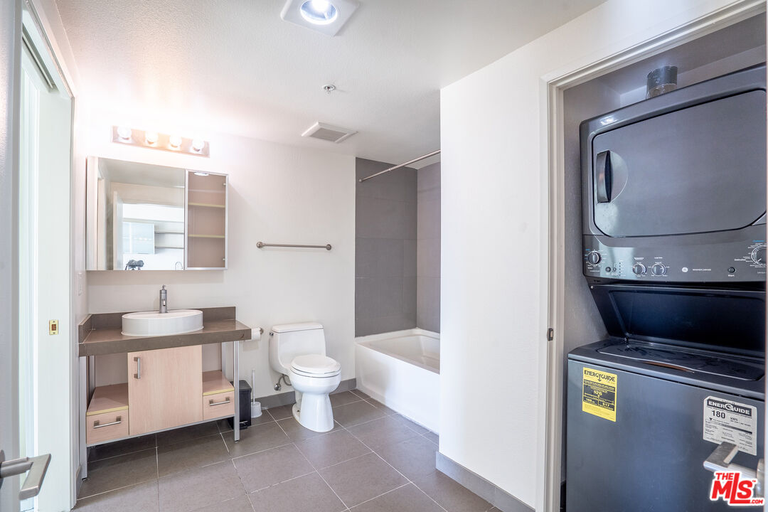 1234 Wilshire Boulevard, Unit 517 Los Angeles, CA 90017 - Photo 5 of 17 a bathroom with a toilet sink and mirror