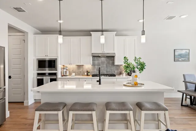 a kitchen with a table chairs stove and cabinets
