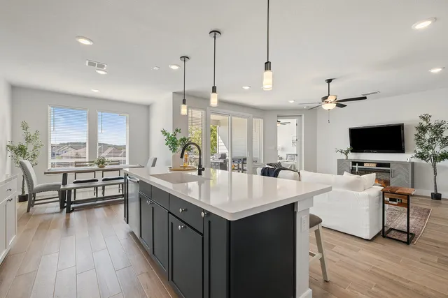 a large kitchen with kitchen island a sink table and chairs